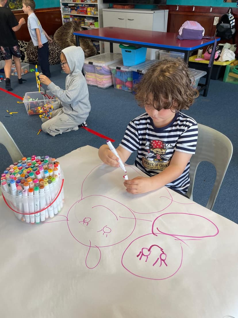 Child drawing with markers during after school care